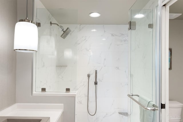 bathroom with toilet, recessed lighting, and a marble finish shower