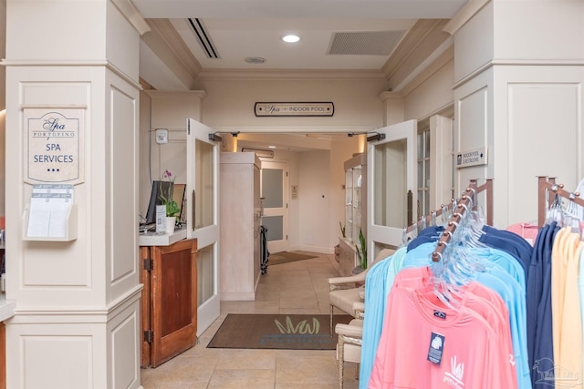 interior space featuring tile patterned floors, visible vents, and ornamental molding