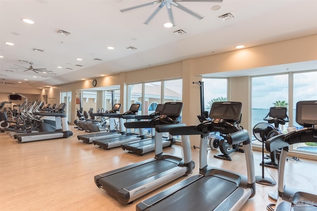 workout area with light hardwood / wood-style floors and ceiling fan