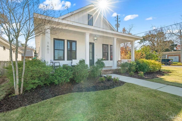 view of front of home with a porch and a front yard