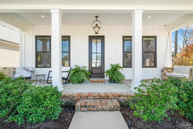 view of exterior entry featuring a porch