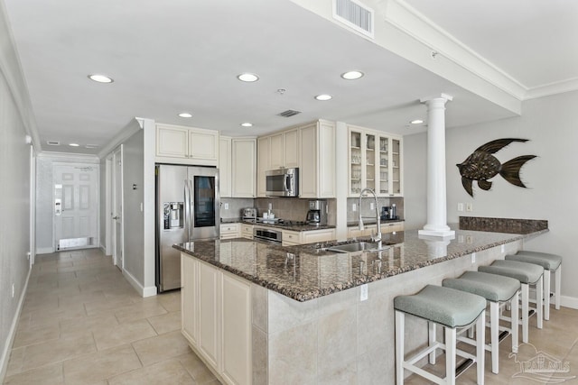 18 Via Deluna Dr Unit 603, Pensacola Beach, FL 32561 - kitchen featuring decorative columns, appliances with stainless steel finishes, recessed lighting, crown molding, and dark stone counters