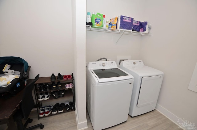 laundry room featuring light hardwood / wood-style floors and independent washer and dryer