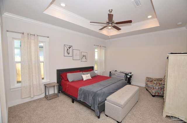 bedroom featuring a raised ceiling, ceiling fan, carpet, and ornamental molding