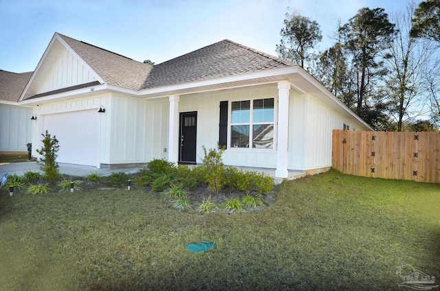 view of front of home with a front yard and a garage