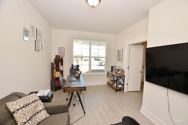 office area with light hardwood / wood-style floors