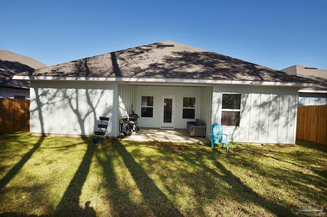 back of property featuring a patio area and a lawn