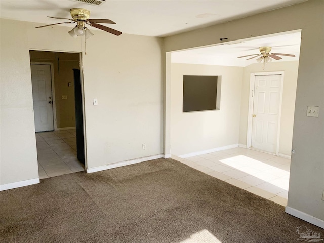 spare room featuring light colored carpet and ceiling fan