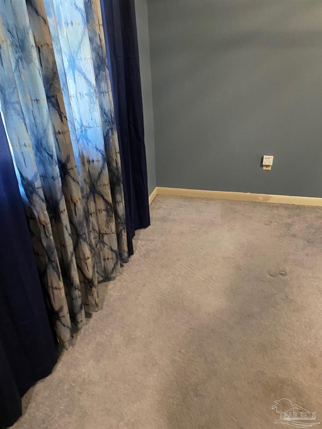 interior space featuring carpet flooring and baseboards