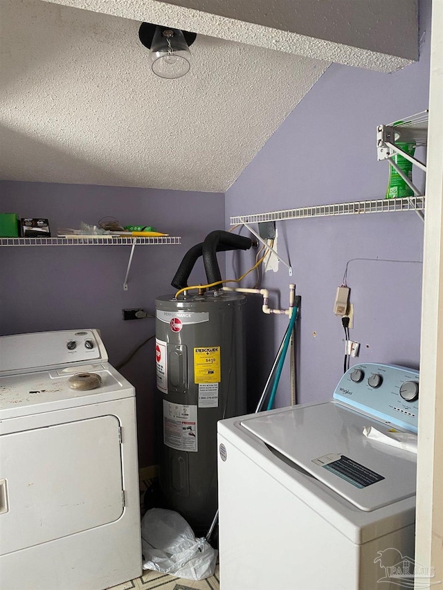 washroom featuring laundry area, electric water heater, independent washer and dryer, and a textured ceiling