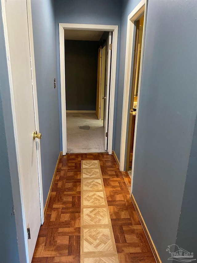 hall featuring baseboards