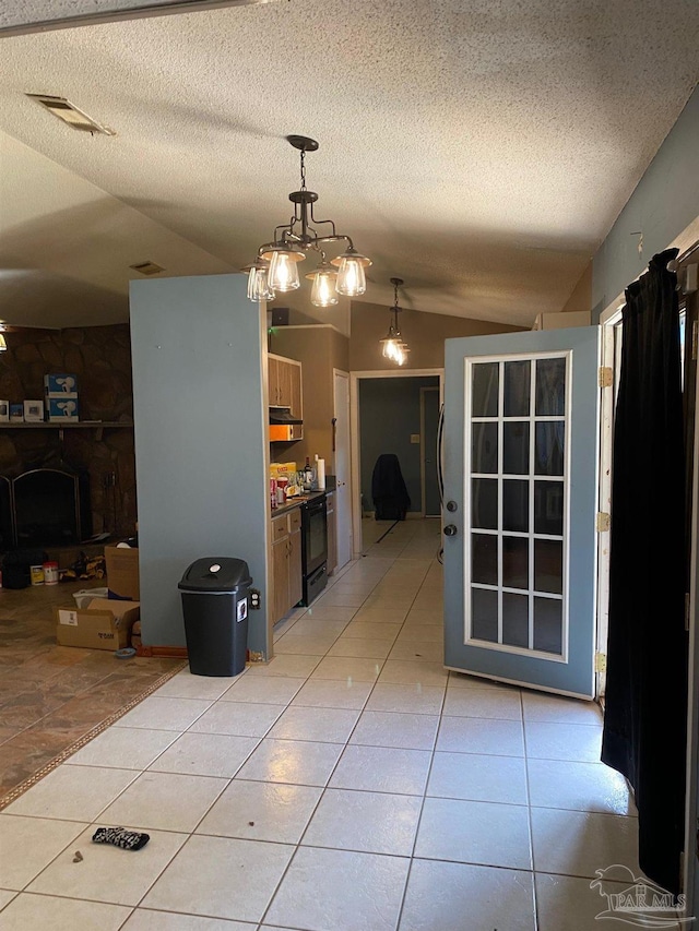 interior space featuring lofted ceiling, visible vents, a textured ceiling, and light tile patterned floors