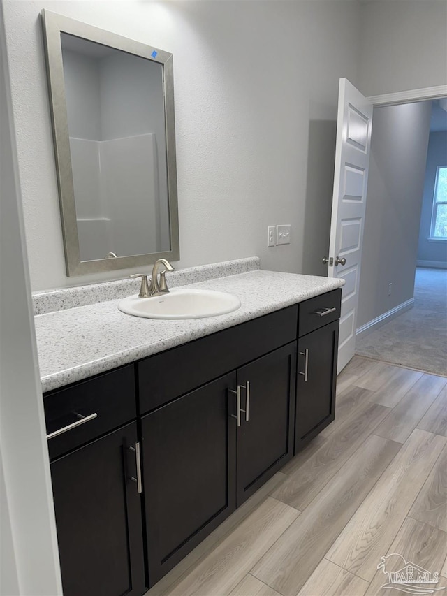 bathroom with vanity and hardwood / wood-style floors