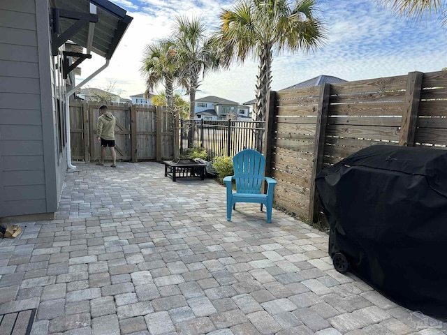 view of patio / terrace with a grill and a fire pit