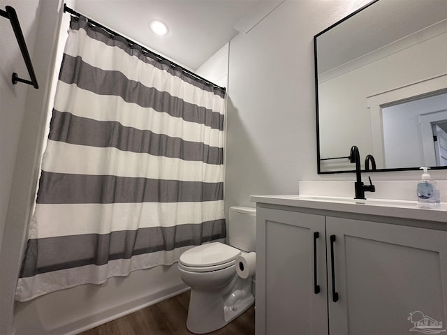 full bathroom featuring toilet, shower / tub combo, hardwood / wood-style floors, and vanity