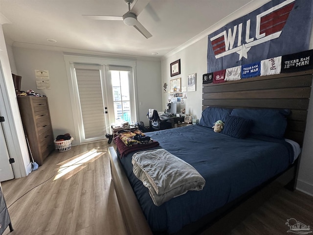 bedroom with ceiling fan, hardwood / wood-style flooring, and ornamental molding