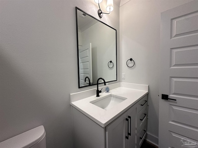 bathroom featuring toilet and vanity