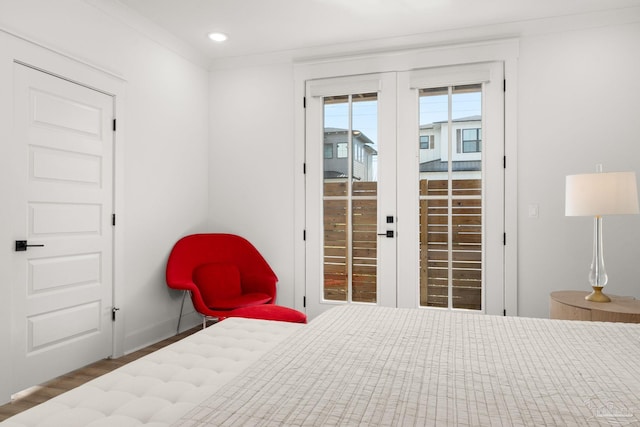 bedroom featuring access to outside, french doors, crown molding, and hardwood / wood-style floors