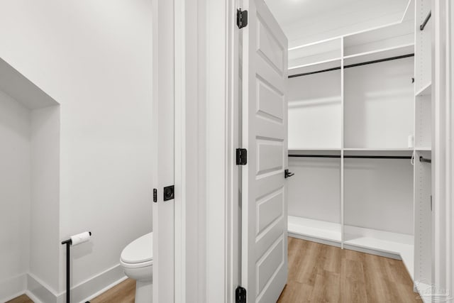 spacious closet with light hardwood / wood-style floors