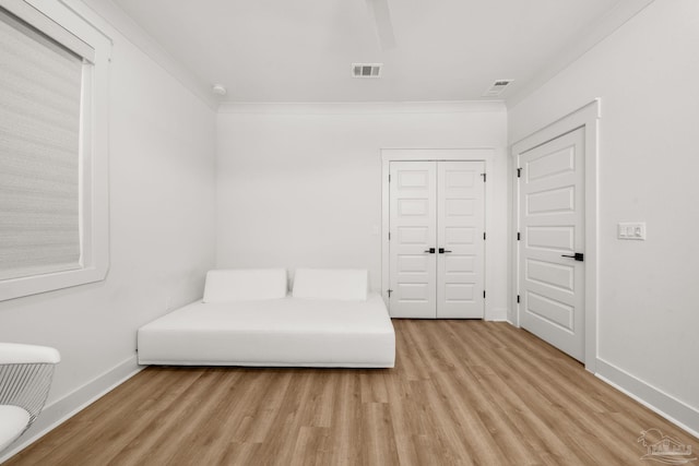 unfurnished room featuring ornamental molding and light hardwood / wood-style floors