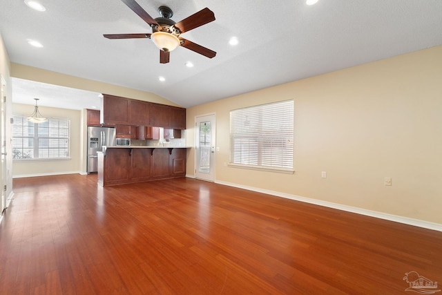 unfurnished living room with ceiling fan, lofted ceiling, and dark hardwood / wood-style flooring