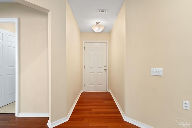 corridor featuring hardwood / wood-style flooring