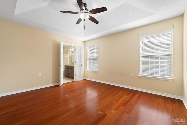 spare room featuring hardwood / wood-style flooring, ceiling fan, and a textured ceiling