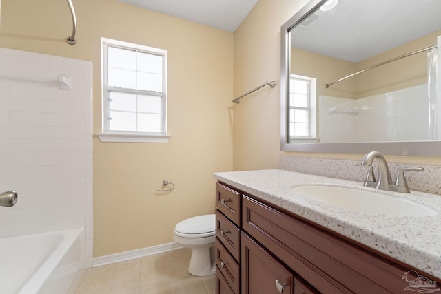 full bathroom with tile patterned floors, toilet, tiled shower / bath combo, and vanity