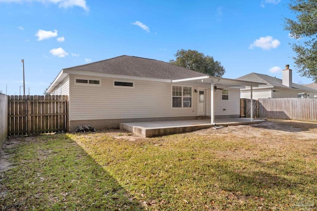 back of house featuring a yard and a patio area