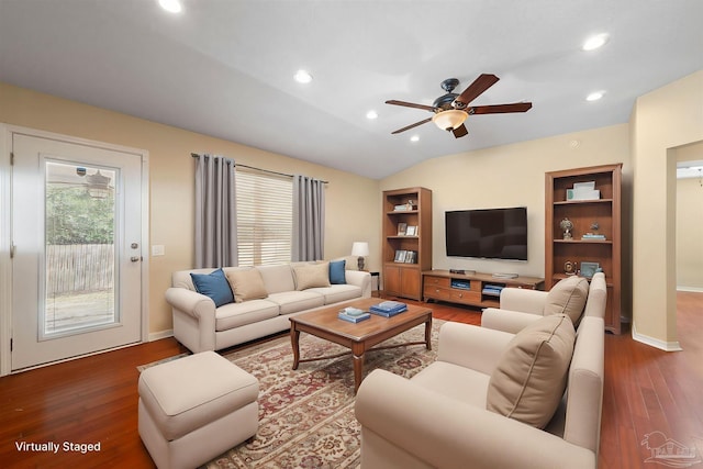 living room featuring dark wood-type flooring, a healthy amount of sunlight, and lofted ceiling