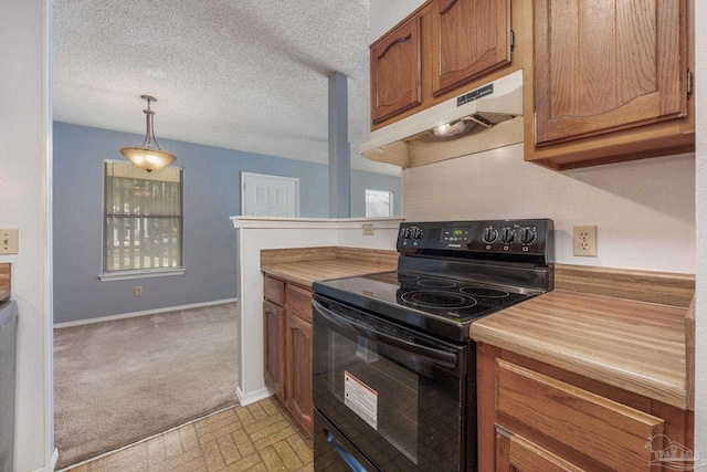 2201 Scenic Hwy Unit M1, Pensacola, FL 32503 - kitchen with black range with electric cooktop, under cabinet range hood, brown cabinets, decorative light fixtures, and light colored carpet