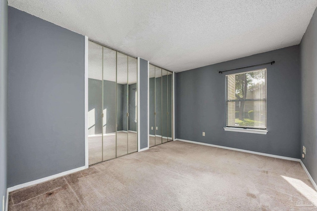 2201 Scenic Hwy Unit M1, Pensacola, FL 32503 - unfurnished bedroom with two closets, carpet flooring, a textured ceiling, and baseboards