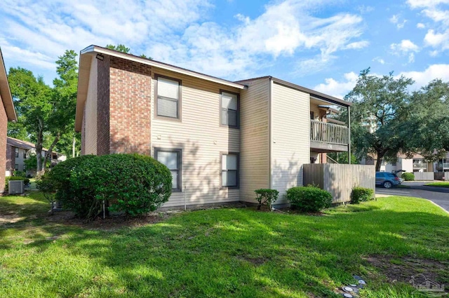 2201 Scenic Hwy Unit M1, Pensacola, FL 32503 - view of property exterior featuring central AC unit, a yard, and brick siding