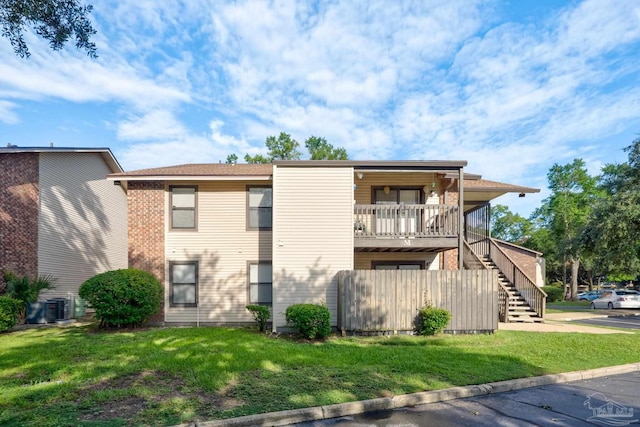 2201 Scenic Hwy Unit M1, Pensacola, FL 32503 - back of house featuring a lawn, stairway, and central AC unit