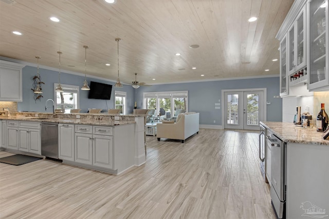 kitchen with ceiling fan, light hardwood / wood-style flooring, white cabinetry, and stainless steel dishwasher