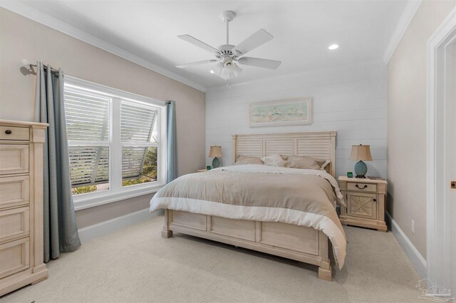 carpeted bedroom with ornamental molding and ceiling fan