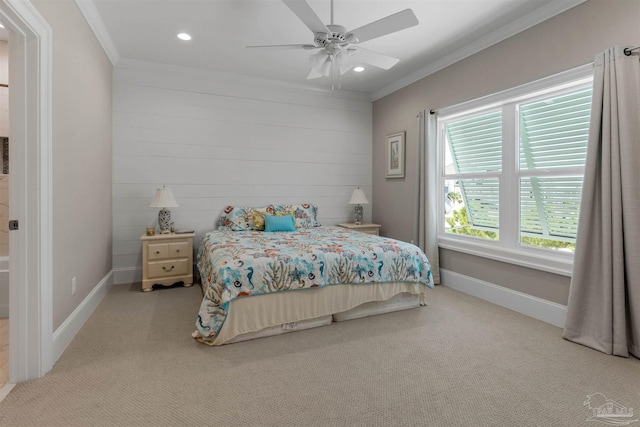 carpeted bedroom with ornamental molding and ceiling fan