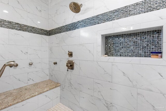 bathroom with a tile shower