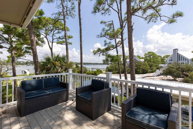 wooden terrace with outdoor lounge area and a water view