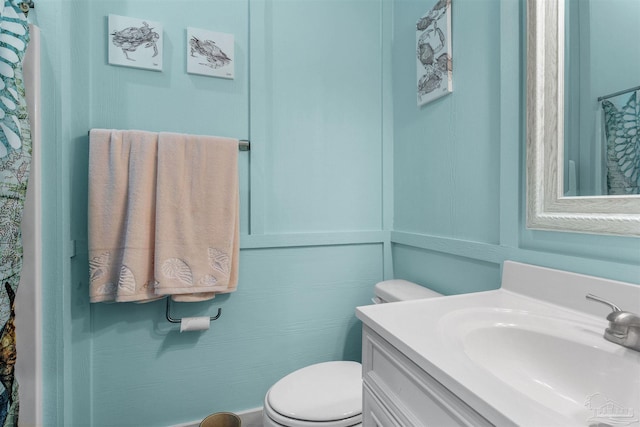 bathroom featuring toilet and vanity