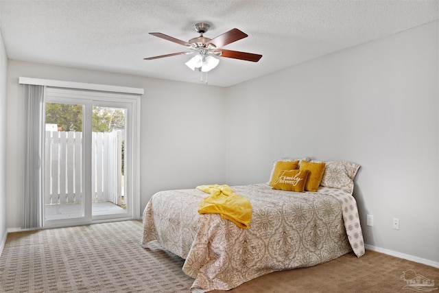 bedroom featuring carpet, access to outside, baseboards, and a textured ceiling