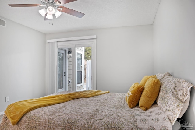 bedroom featuring a textured ceiling, access to outside, ceiling fan, and visible vents