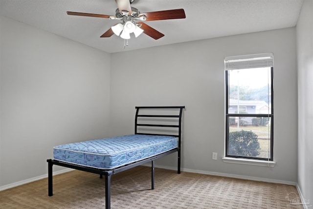 bedroom with baseboards and a ceiling fan