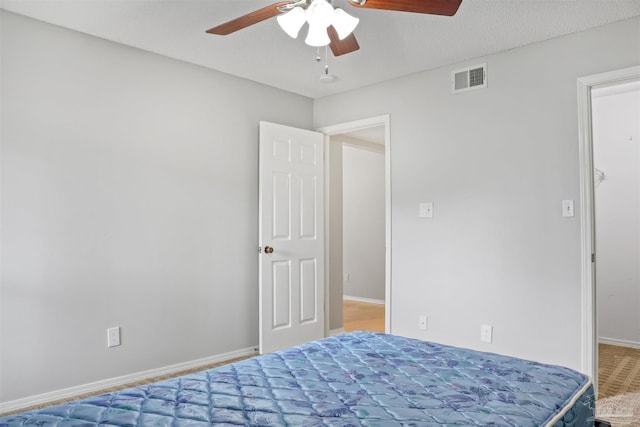 bedroom featuring a ceiling fan, visible vents, and baseboards