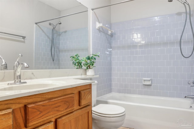 bathroom with bathtub / shower combination, vanity, and toilet