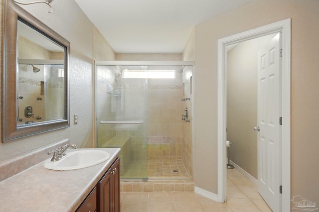 bathroom with vanity, tile patterned floors, toilet, and a shower stall