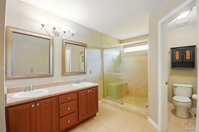 bathroom featuring tile patterned floors, visible vents, a sink, and a stall shower