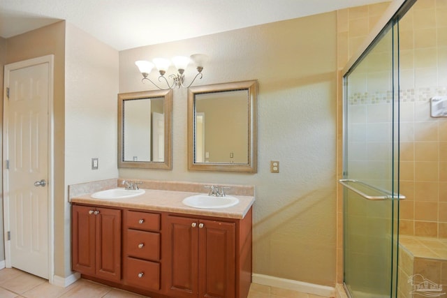 full bath with double vanity, an inviting chandelier, a sink, and a stall shower