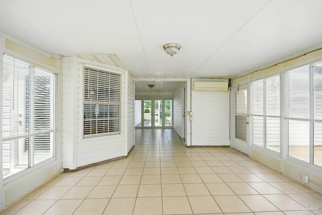 unfurnished sunroom featuring an AC wall unit
