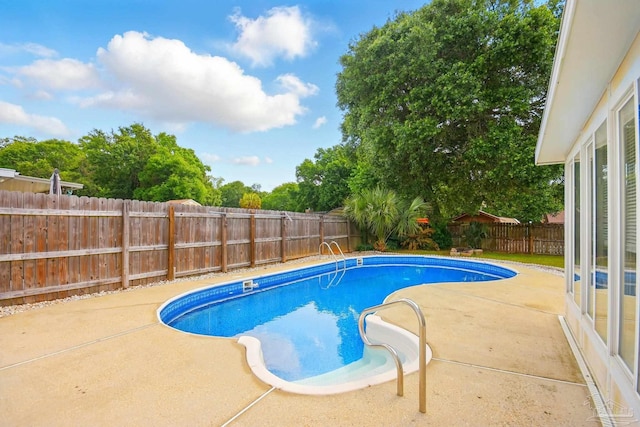 view of pool featuring a fenced backyard, a fenced in pool, and a patio area